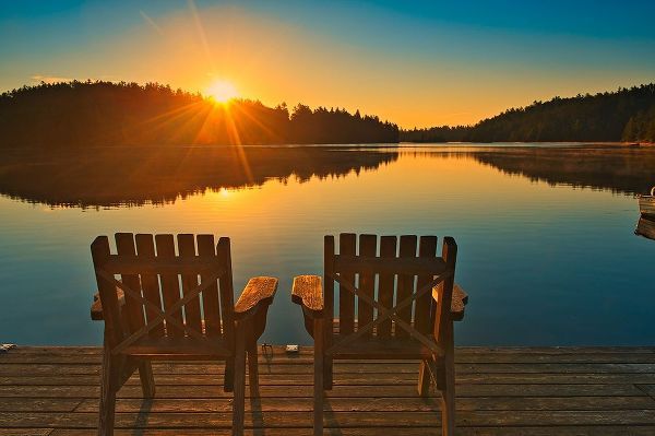 Canada-Ontario-Temagami Muskoka chairs on Snake Island Lake dock at sunrise
